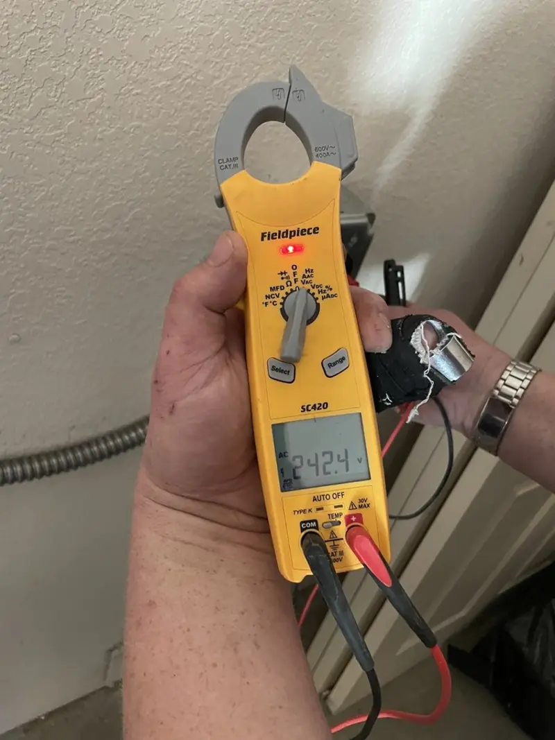 Voltage testing with clamp meter during Ceiling Fan Installation in Howard